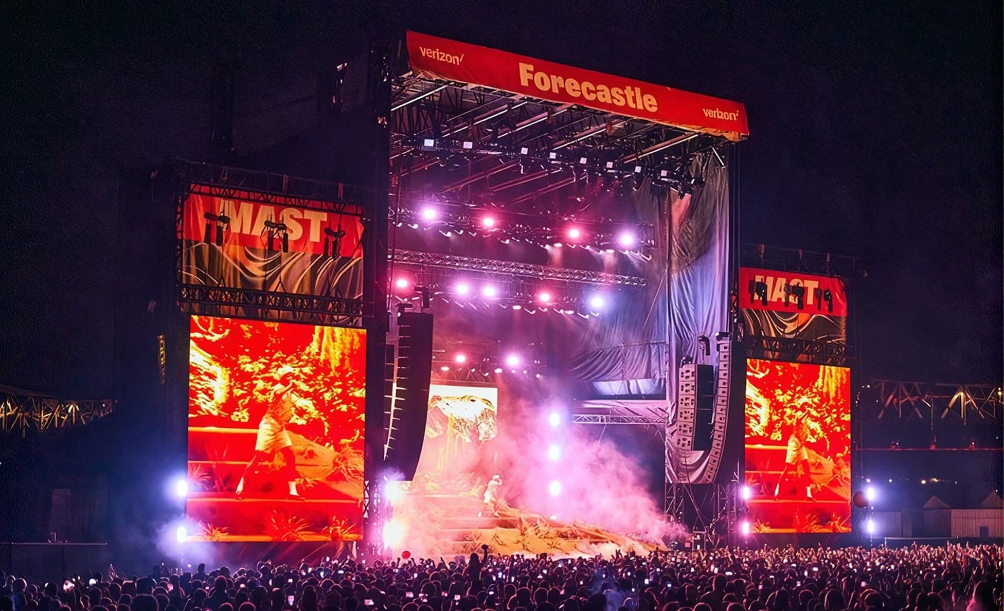 Night view of the red-lit Mast Stage at Forecastle Festival with a phones-up crowd