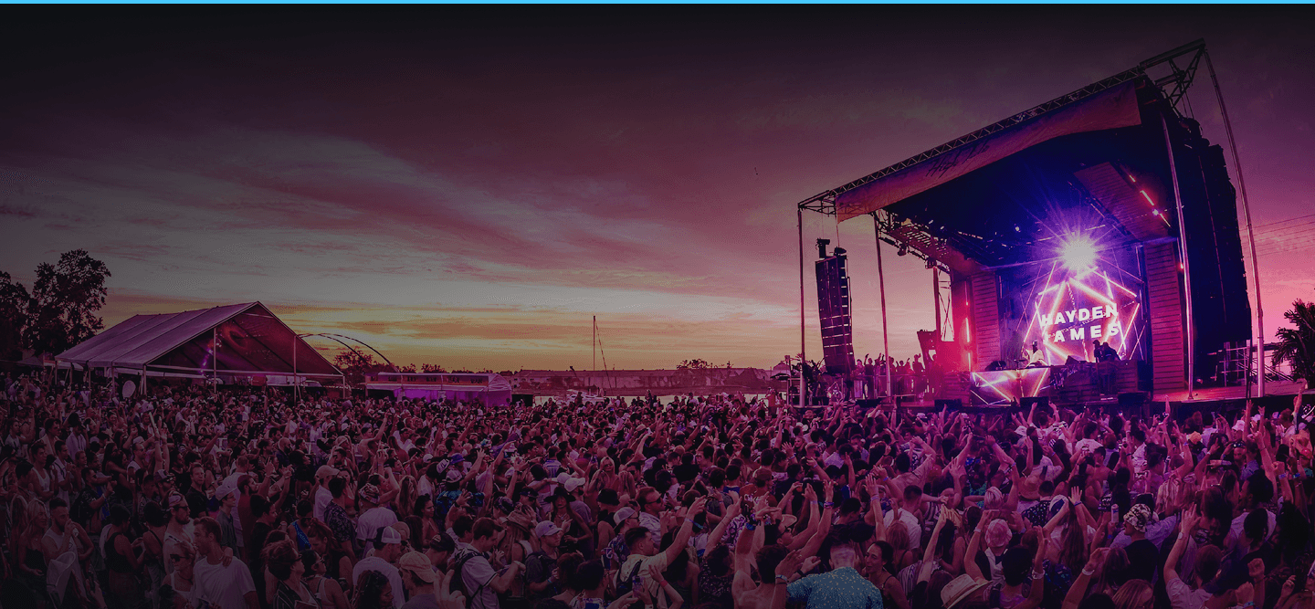 Festival main stage at sunset with crowd — Hayden James performance